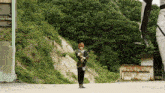 a man standing in a field holding a sword