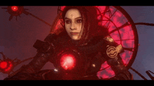 a woman with a cross on her forehead stands in front of a red circle