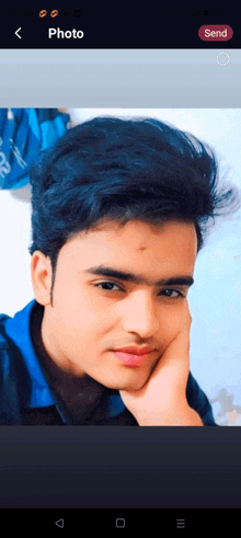 a young man 's face is shown on a phone screen with the word photo at the top