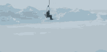 a person is riding a ski lift with their arms in the air
