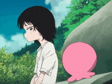 a girl in a white shirt stands next to a pink balloon