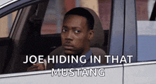 a man in a car with the words joe hiding in that mustang
