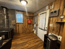 a room with wood paneling and a red bag that says ' i love you '