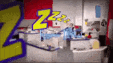 a group of people are sitting in a room with a sign that says `` zzz '' .