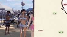 a woman in a bikini stands on a beach next to a man in a striped shirt