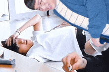 a man is laying on the floor with his hand on his head