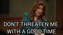 a woman sitting in a chair with the words " do n't threaten me with a good time " on the bottom