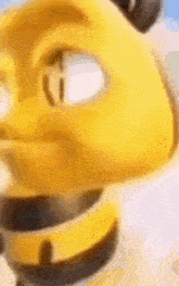 a close up of a yellow cartoon character with a black collar on a white surface .
