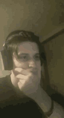 a man wearing headphones is making a funny face .