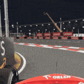 a race track with lenovo banners along the fence