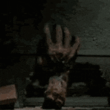 a person is laying on their back and giving the middle finger .