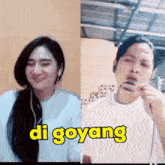 a man and a woman are singing a song with di goyang written on the bottom