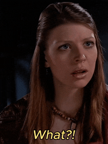 a woman with a necklace and earrings is asking what