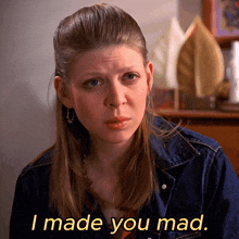 a woman in a denim jacket says " i made you mad " in yellow letters