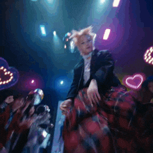 a woman in a plaid skirt is sitting on a couch in a crowded room