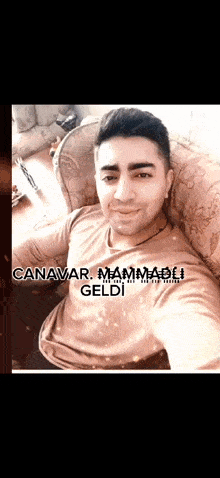 a man is sitting in a chair with the name canavar mammadi written on his shirt