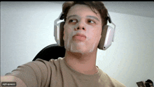 a man wearing headphones has a mask on his face and the name ygt_ayazzz is on the bottom right