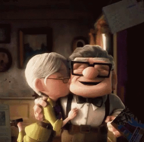 a scene from the movie Up where Ellie Fredricksen is kissing Carl Fredricksen on the cheek and he smiles