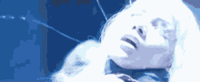a close up of a woman 's face in a blue light