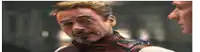 robert downey jr. is talking to a man in a superhero costume .