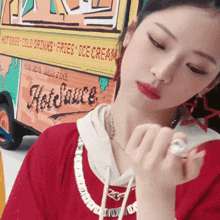 a girl in front of a hot sauce truck
