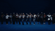 a group of women are dancing and one of them is wearing a hat that says mlb
