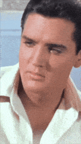 a close up of a man 's face with a serious look on his face