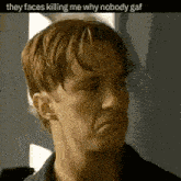 a man in a black shirt is making a funny face .