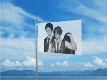 a flag with a picture of two men on it with the letter j on the bottom