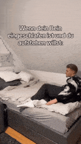 a man is laying on a bed with the words wenn dein bein eingeschlafen ist und du aufstehen willst