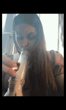 a woman is smoking a bong with a lighter in her hand