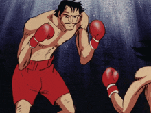 a man in red shorts and boxing gloves