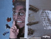 a picture of a man behind a door with a note on the wall that says " i can 't hear you "