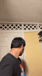 a man standing in front of a door with a lattice railing
