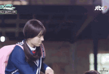 two people in school uniforms are standing next to each other and one of them is wearing a wig