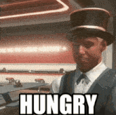 a man wearing a top hat says hungry in a restaurant