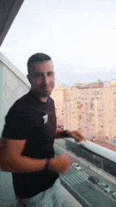 a man in a black t-shirt with the letter j on it