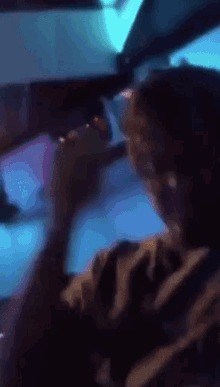a blurry picture of a person in a car with blue lights