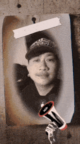 a black and white photo of a man with a hat that says vans