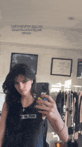 a woman taking a picture of herself in a mirror with the words devil couldn 't reach me so
