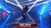 a woman is standing in a dark room with a sign that says iyo sky damage ctrl on it