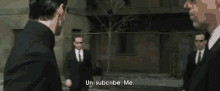 a man in a suit says " un-subscribe me " to two other men