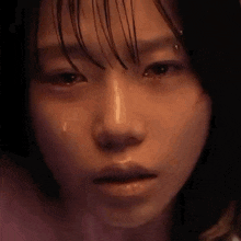a close up of a woman 's face with a tear running down her eye .