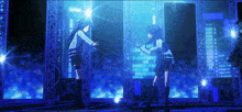 a couple of girls are standing on a stage with a blue background