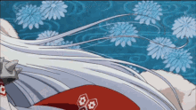 a close up of a person 's hair with a blue background and flowers