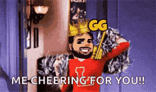 a man with a crown on his head is cheering for someone