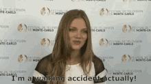 a woman says i 'm a walking accident actually in front of a wall that says festival de television de monte-carlo