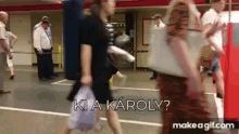 a group of people walking down a street with the words ki a karoly written on the bottom
