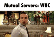 a man sitting in front of a bar with the words mutual servers wuc above him