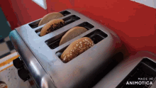 four bagels are being toasted in a toaster that is made in animatica